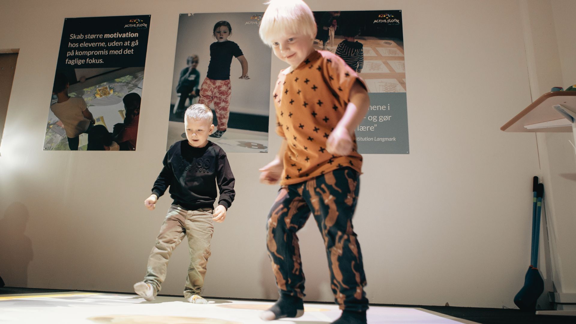 kids playing on interactive projector floor